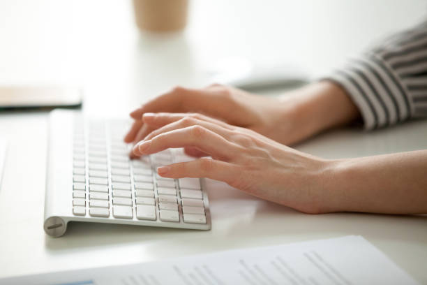 istock Businesswoman working on computer, female hands typing on keyboard closeup 953659078