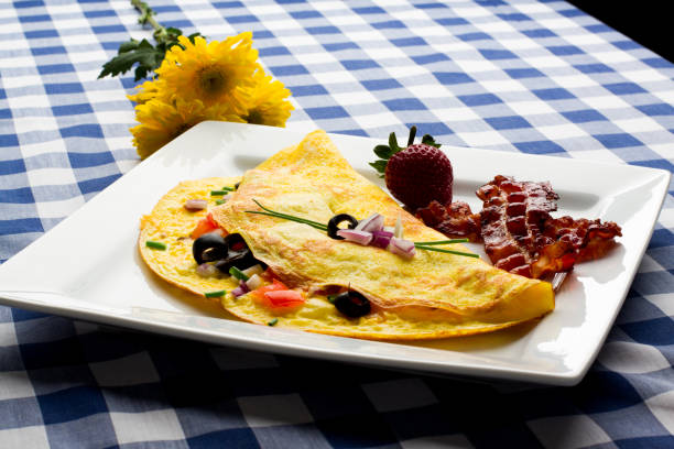 Fancy Gourmet Low Carb Onion Spinach and Tomato Omelet Gourmet omelet with onion, tomato and spinach and cheese.  This is a perfect ketogenic diet low carb breakfast goodfood stock pictures, royalty-free photos & images