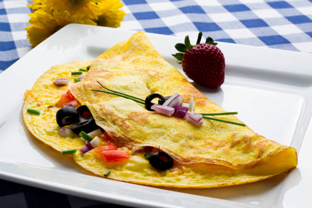 Fancy Gourmet Low Carb Onion Spinach and Tomato Omelet Gourmet omelet with onion, tomato and spinach and cheese.  This is a perfect ketogenic diet low carb breakfast goodfood stock pictures, royalty-free photos & images