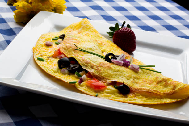 Fancy Gourmet Low Carb Onion Spinach and Tomato Omelet Gourmet omelet with onion, tomato and spinach and cheese.  This is a perfect ketogenic diet low carb breakfast goodfood stock pictures, royalty-free photos & images