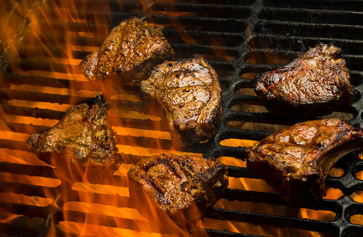 Delicious Grilled Lamb or Pork Chops, part of a ketogenic or low carb diet flaming on a grill