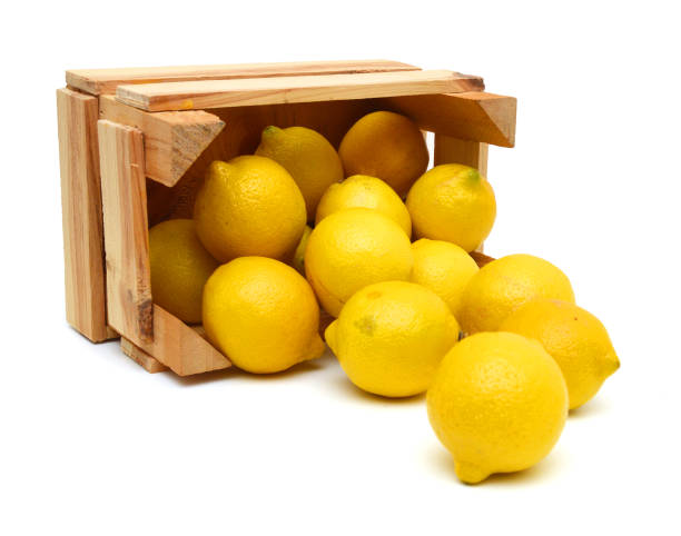 istock fresh lemons in a wooden box on a white background 953665060