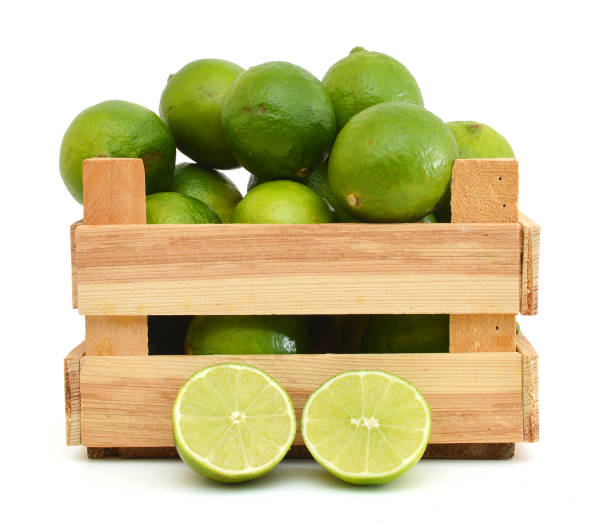 istock Limes  in wooden crate on white background 953665388