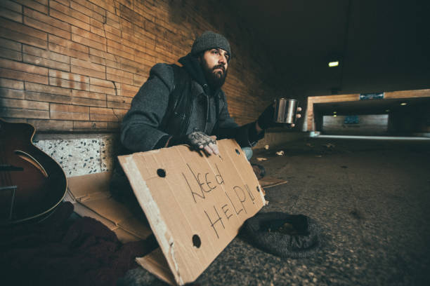 istock Homeless man begging in underpass tunnel 953665688