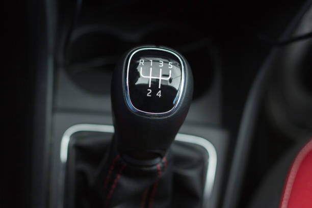 istock manual transmission gear shift on dark background, close-up 953669508