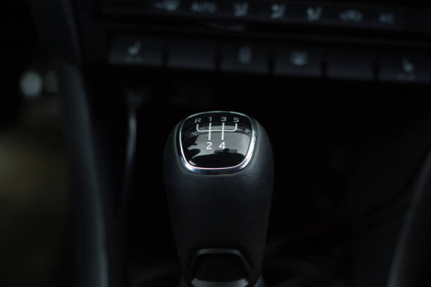 istock manual transmission gear shift on dark background, close-up 953669512