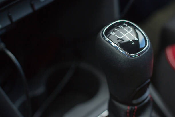 istock manual transmission gear shift on dark background, close-up 953669530