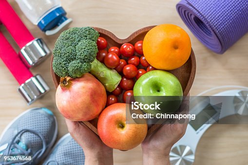 istock Healthy lifestyle concept, clean food good health dietary in heart dish with sporty gym aerobic body exercise workout training class equipment, weight scale and sports shoes in fitness center 953674568