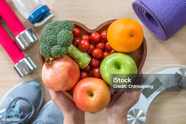 Healthy Lifestyle Concept Clean Food Good Health Dietary In Heart Dish With Sporty Gym Aerobic Body Exercise Workout Training Class Equipment Weight Scale And Sports Shoes In Fitness Center Stock Photo - Download Image Now