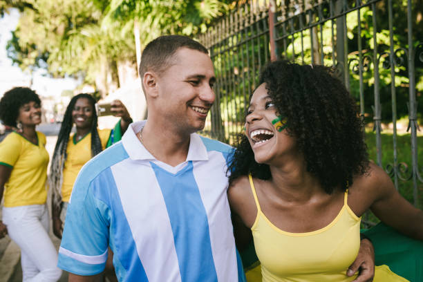 argentinian supporter with brazilian woman in the streets - young adult argentinian culture argentinian ethnicity black imagens e fotografias de stock