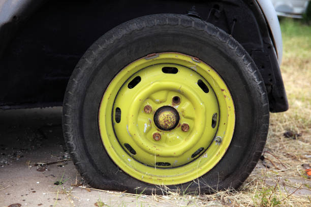 Close up shut of broken car tire in parking lot