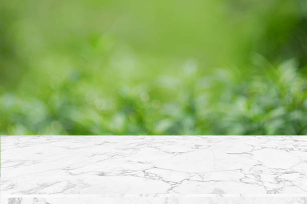 istock Blank marble table top on green nature abstract bokeh background f 953686222