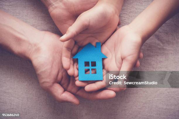 Adult And Child Hands Holding Paper House Family Home And Homeless Shelter Concept Stock Photo - Download Image Now