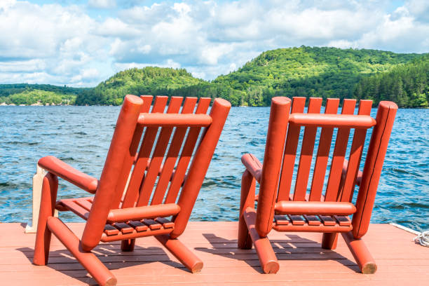 istock Red wooden chairs on the dock on a late summers afternoon 953686384