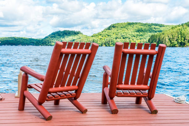 istock Red wooden chairs on the dock on a late summer afternoon 953686392