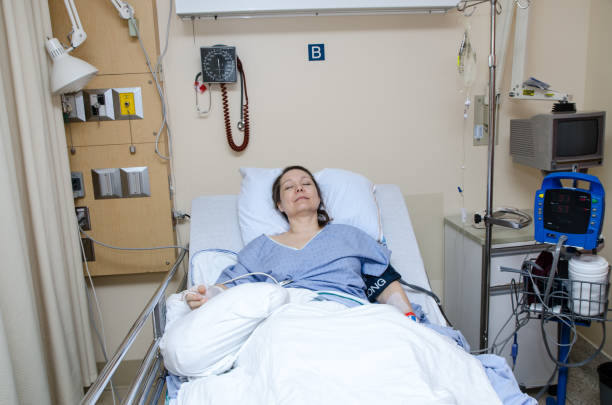 istock Woman sleeping in hospital bed after surgery 953686638