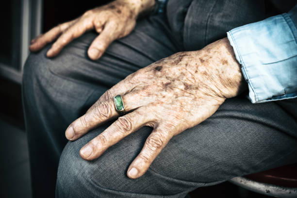 istock Senior man sitting on chair with his hands on knees 953686786