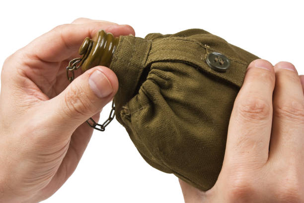 istock hiking flask in hand isolated on white background 953691498