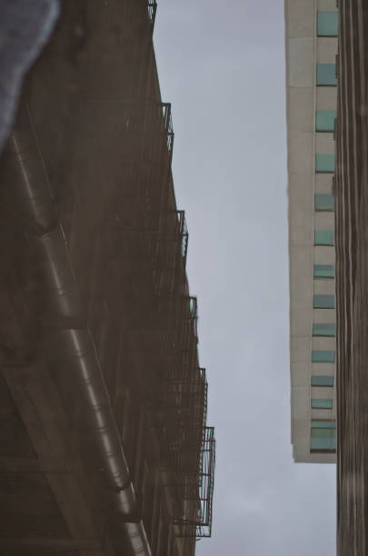 istock The long reflection of a city in a puddle. 953694200