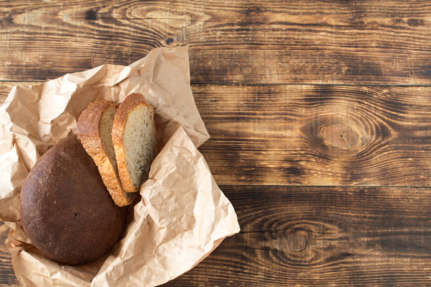 istock Fresh bread on a dark wooden table 953695724