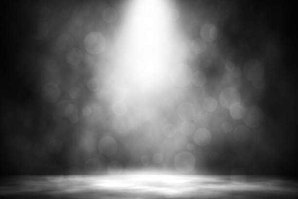 istock White spotlight bokeh smoke entertainment background. 953698158