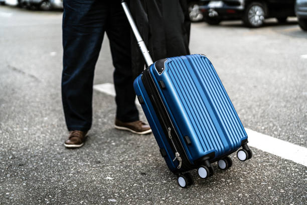 istock Businessman walking with suitcase 953698692
