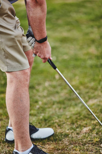 istock Male golfer wearing fitness tracker while playing golf 953707284