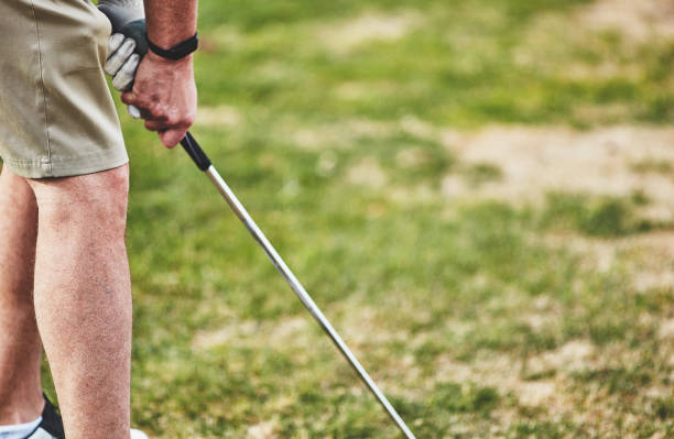 istock Male golfer wearing fitness tracker while playing golf 953707322