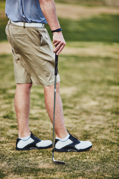 istock Male golfer wearing fitness tracker while playing golf 953708476