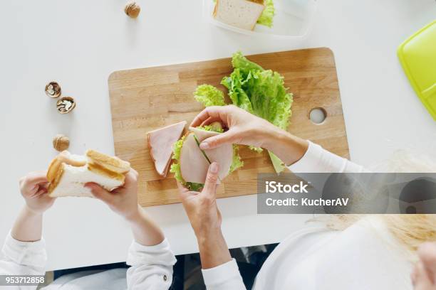 Mother With Daughter Eating Sandwiches At Home In The Kitchen Top View Stock Photo - Download Image Now