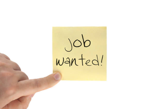 istock Job Wanted text on adhesive note and hand, isolated on white. Notepaper business concept 953713932