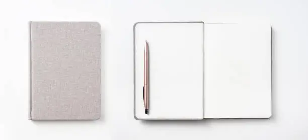 Photo of Top view of hardcover gray linen notebook and ballpoint pen