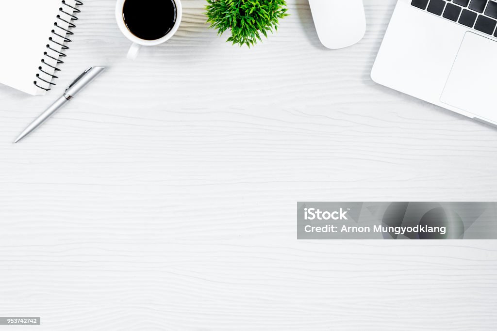 White wood office desk table and equipment for working with black coffee  in top view and flat ray concept. Desk Stock Photo