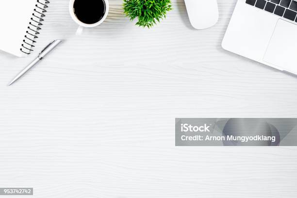 White Wood Office Desk Table And Equipment For Working With Black Coffee In Top View And Flat Ray Concept Stock Photo - Download Image Now