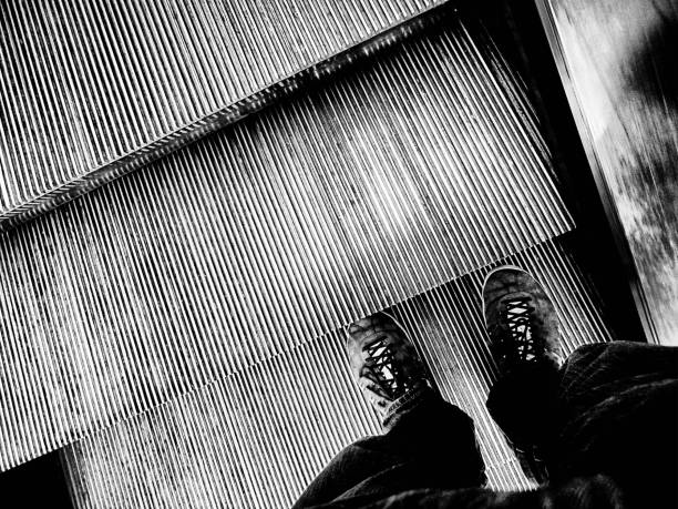 istock Pair of shoes on an escalator 953752658