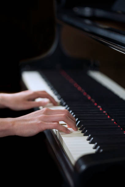 istock A woman's hand playing the piano 953758470