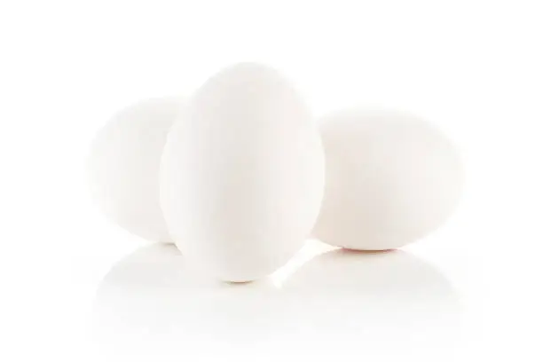 Photo of Fresh raw white eggs isolated on white