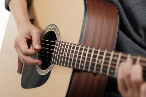 istock Woman's hands playing acoustic guitar. 953764416
