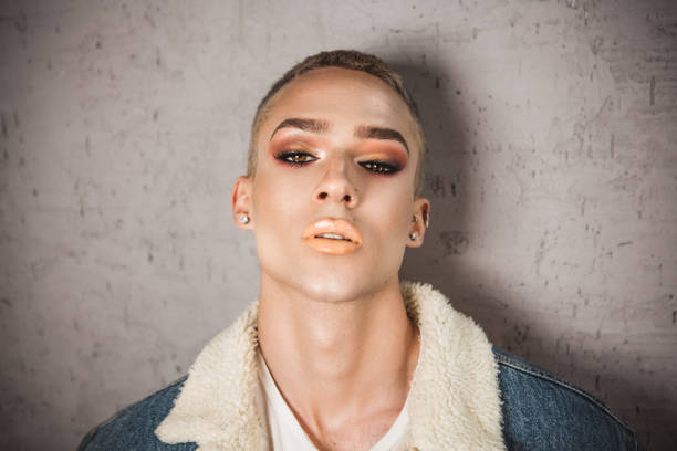 Portrait of young person with ambiguous gaze. Portrait of young person posing in studio gender fluid photos stock pictures, royalty-free photos & images