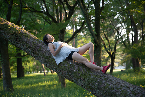 Woman sleeping on a tree