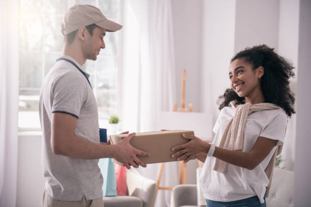 istock Positive friendly man giving the package 953769720