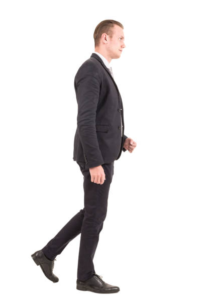 istock Businessman walking forward isolated on white background 953771970