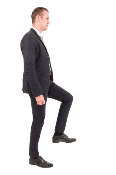 istock Businessman step up a staircase isolated on white background 953771988