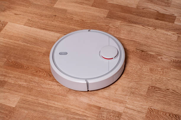 istock robotic vacuum cleaner runs on laminate floor. modern smart cleaning technology housekeeping 953774922