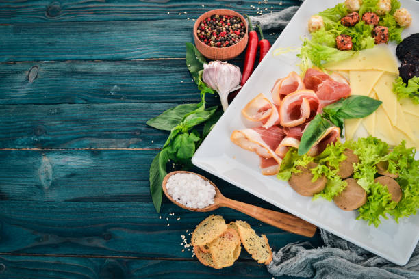istock Cold snacks. Bacon, Cheese, Liver Paste. Top view. On a wooden background. Copy space. 953774990