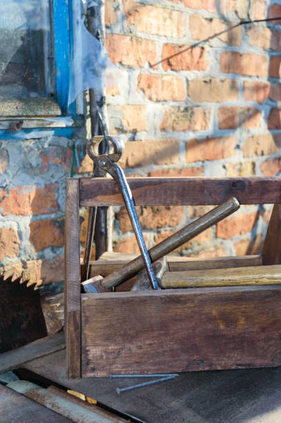 istock Vintage Toolbox with tools. Old wooden box with building tools, boards for repair. Carpenter toolbox. Old working tools. 953778116
