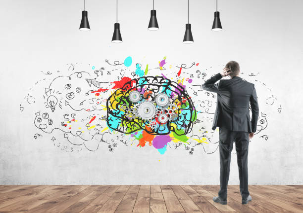 istock Rear view businessman scratching head, cog brain 953778862