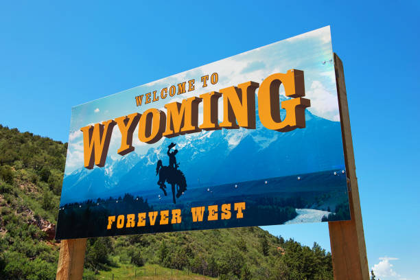 Welcome to Wyoming sign 07/13/2015 - Newcastle, Wyoming, USA: Welcome to Wyoming sign with text "Forever West" and horse with cowboy west direction photos stock pictures, royalty-free photos & images
