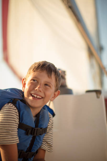 istock Little boy is happy on sailboat 953779404