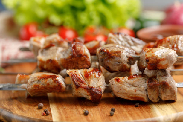 istock Appetizing shish kebab from pork cooked on an open fire. Still-life on a wooden background. 953783998